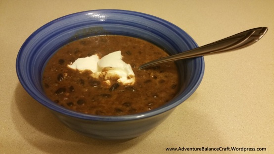 Spicy Black Bean Soup in a Bowl with Sour Cream